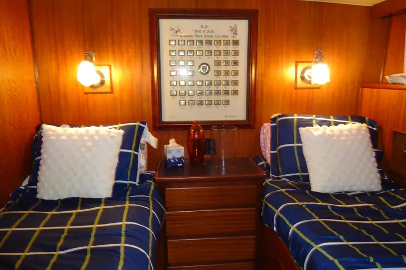 Slide: The Image of 1977 Hatteras 53 Motor Yacht cabin with twin beds, plaid bedding, and framed wall art. - 52