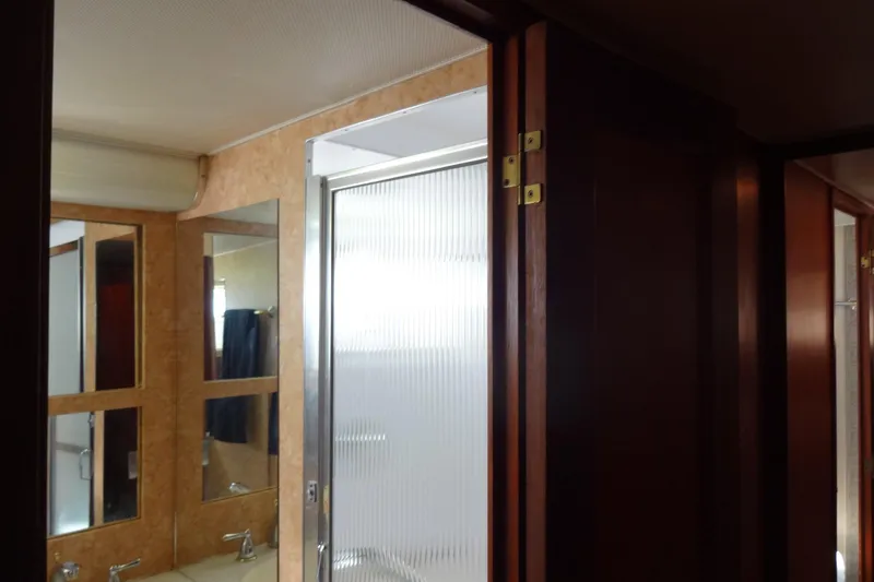 Slide: The Image of Interior of 1977 Hatteras 53 Motor Yacht bathroom with mirrors and shower. - 54