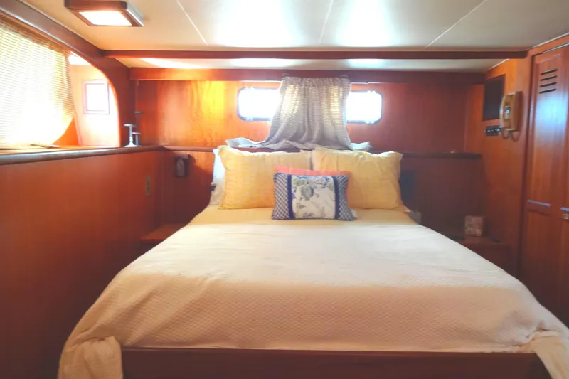 Slide: The Image of Cozy bedroom interior of 1977 Hatteras 53 Motor Yacht with wooden paneling and soft lighting. - 61