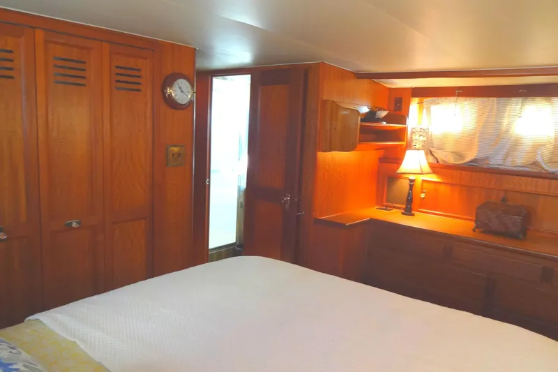 Slide: The Image of Cozy cabin interior of 1977 Hatteras 53 Motor Yacht with wooden furnishings and soft lighting. - 63
