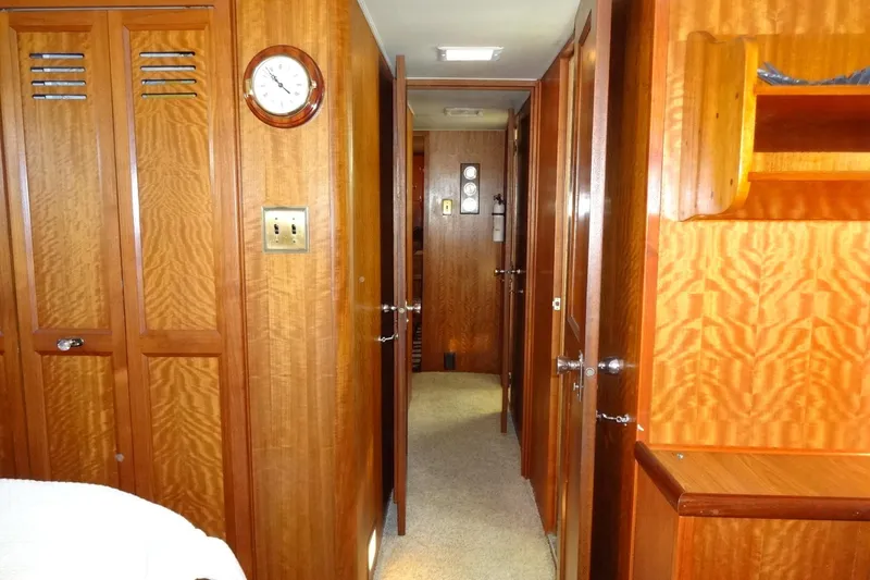 Slide: The Image of Interior of 1977 Hatteras 53 Motor Yacht with wooden paneling and hallway view. - 66