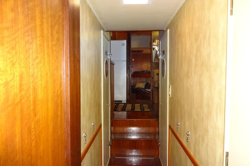 Slide: The Image of Interior hallway of a 1977 Hatteras 53 Motor Yacht with wooden finishes. - 69