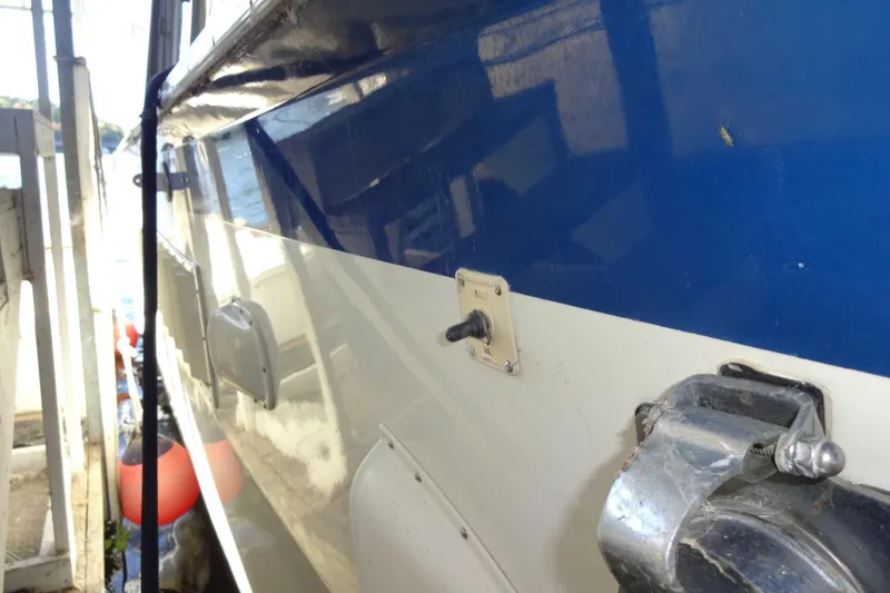 Slide: The Image of Side view of a 1977 Hatteras 53 Motor Yacht with blue and white hull. - 7