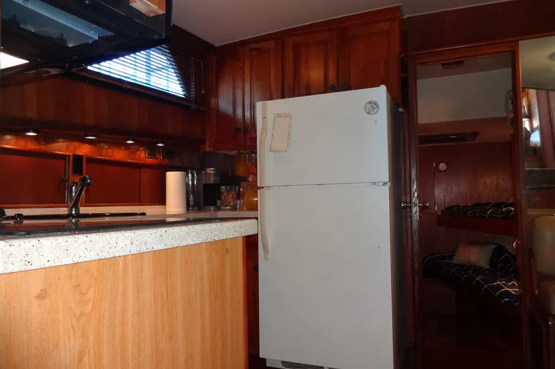 Slide: The Image of Interior of 1977 Hatteras 53 Motor Yacht with kitchen and cozy cabin area. - 71