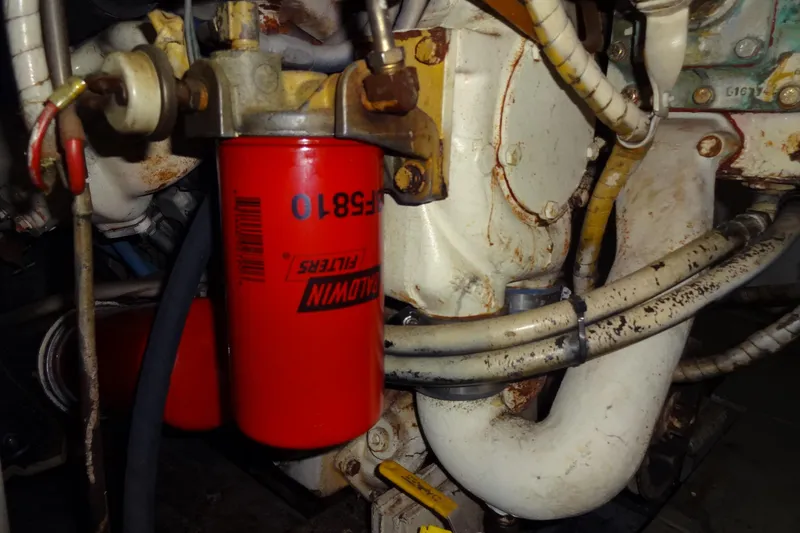 Slide: The Image of Engine compartment of a 1977 Hatteras 53 Motor Yacht with a red Baldwin filter. - 75