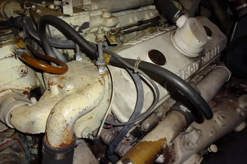 Slide: The Image of Engine of a 1977 Hatteras 53 Motor Yacht, showing hoses and components. - 76