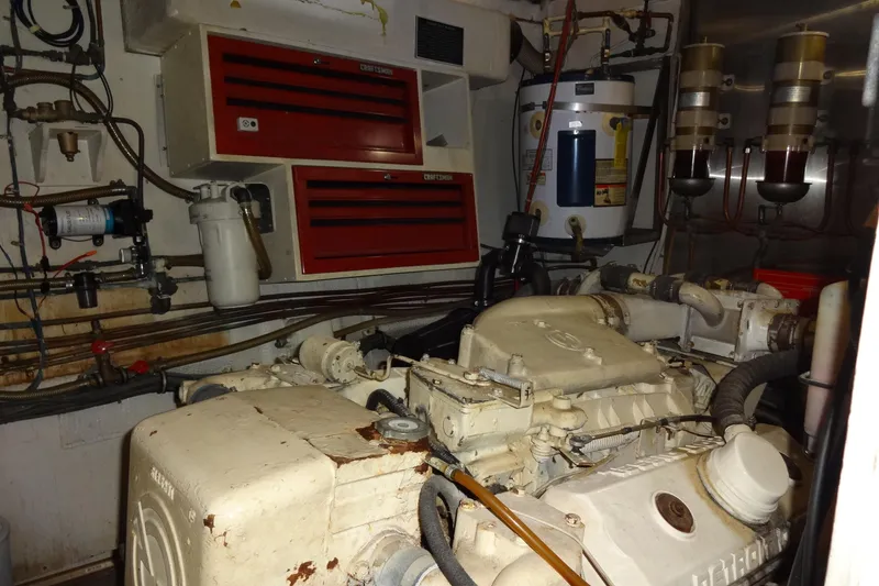 Slide: The Image of Engine room of a 1977 Hatteras 53 Motor Yacht with visible machinery and equipment. - 83