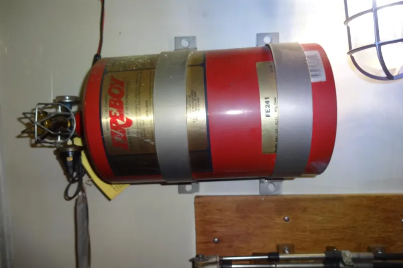Slide: The Image of Fire extinguisher mounted on 1977 Hatteras 53 Motor Yacht interior wall. - 86