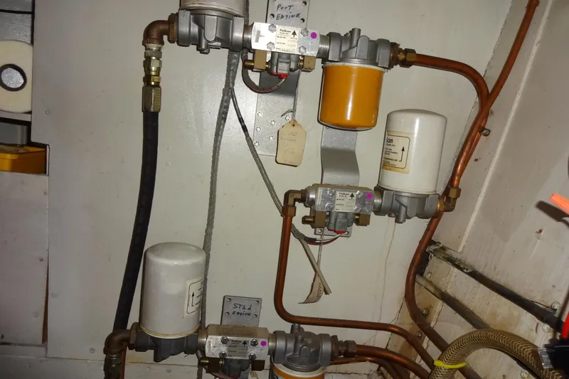 Slide: The Image of Engine room of 1977 Hatteras 53 Motor Yacht showing fuel filters and piping system. - 89