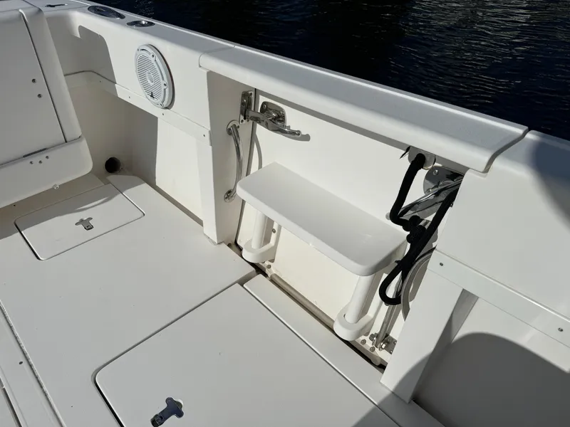 Slide: The Image of 2014 Intrepid 327 Center Console boat interior with seating and storage compartments. - 10