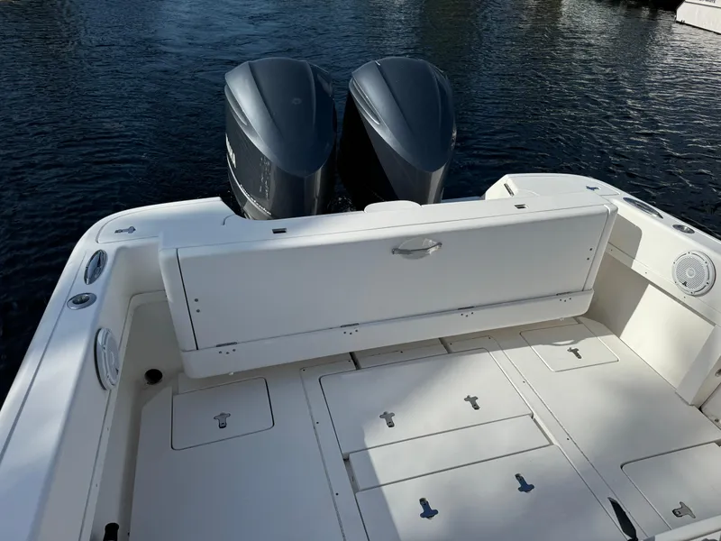 Slide: The Image of 2014 Intrepid 327 Center Console boat with dual engines on calm water. - 17