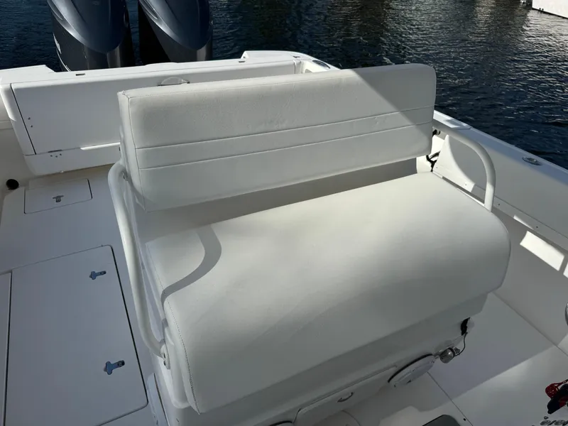 Slide: The Image of White seating on a 2014 Intrepid 327 Center Console boat, with water in the background. - 18