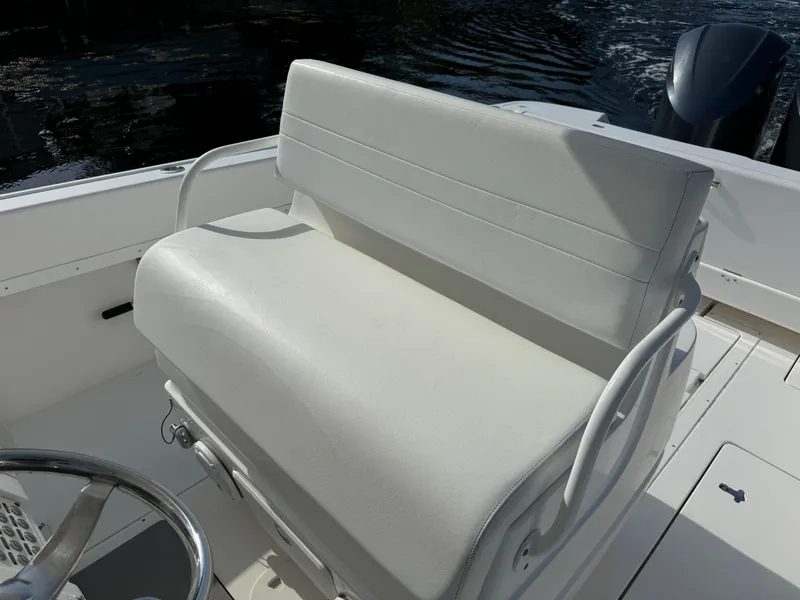 Slide: The Image of White seating on 2014 Intrepid 327 Center Console boat, with water in the background. - 19