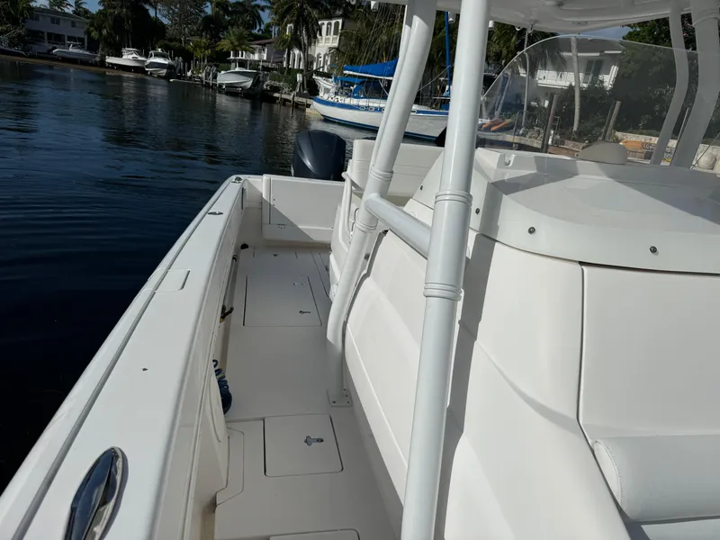 Slide: The Image of 2014 Intrepid 327 Center Console boat docked by waterfront homes. - 21