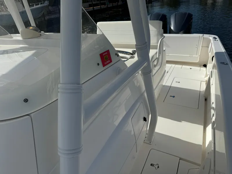 Slide: The Image of 2014 Intrepid 327 Center Console boat deck with seating and storage compartments. - 22