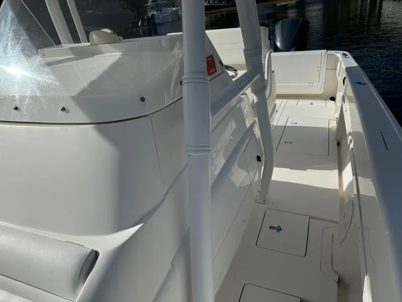 Slide: The Image of 2014 Intrepid 327 Center Console boat with sleek white deck and seating. - 23