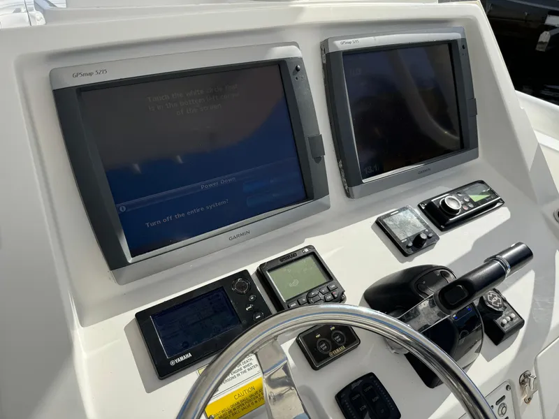 Slide: The Image of 2014 Intrepid 327 Center Console dashboard with dual Garmin displays and navigation controls. - 5