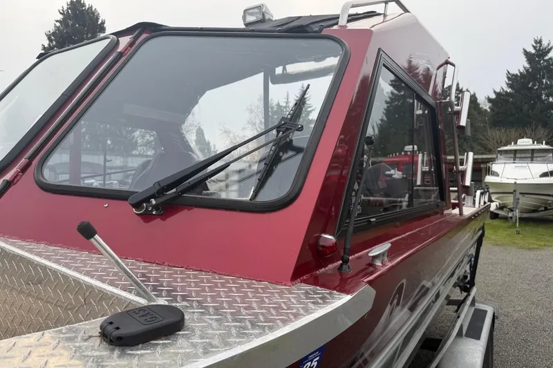 Slide: The Image of 2010 Thunder Jet 21 Luxor OB boat with red exterior and windshield wipers. - 10