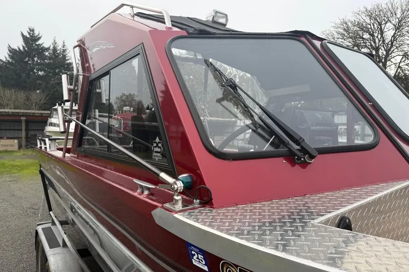 Slide: The Image of 2010 Thunder Jet 21 Luxor OB boat with ladder and trailer on gravel. - 11