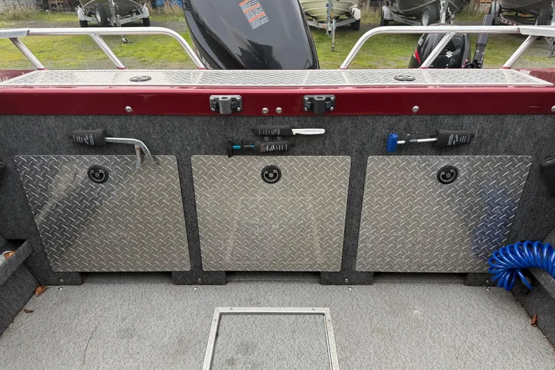 Slide: The Image of 2010 Thunder Jet 21 Luxor OB boat storage compartments with diamond plate covers. - 15