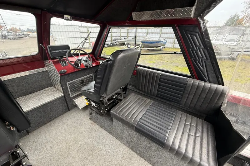 Slide: The Image of Interior of 2010 Thunder Jet 21 Luxor OB boat with black seating and steering console. - 19