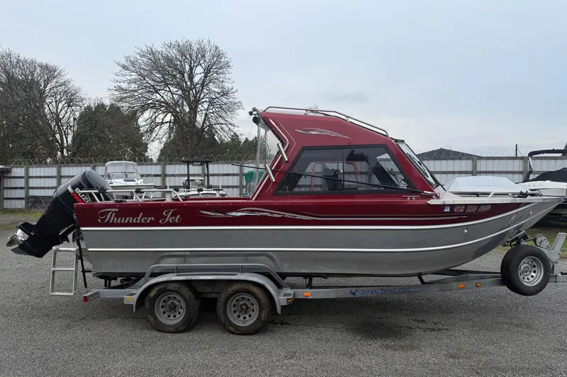 Slide: The Image of 2010 Thunder Jet 21 Luxor OB boat on trailer with Suzuki outboard motor. - 2