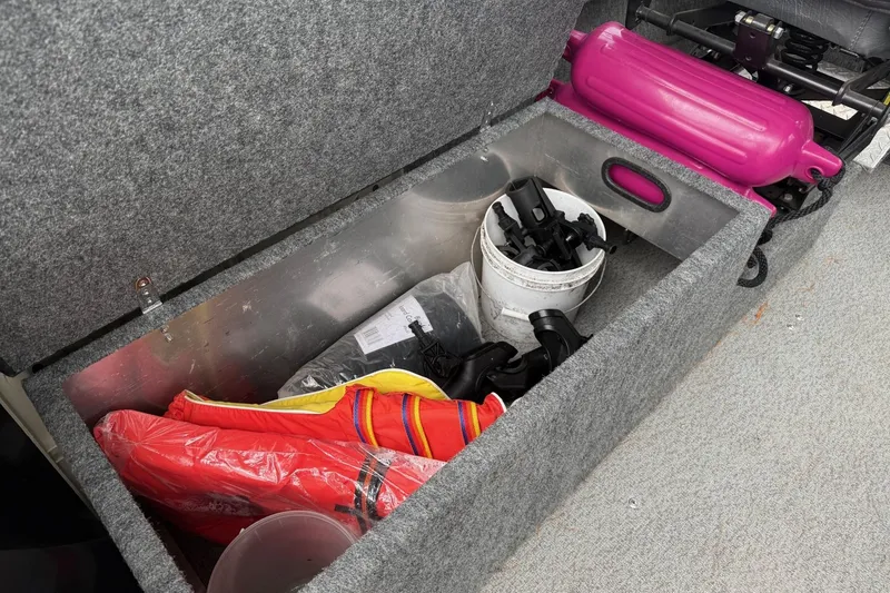 Slide: The Image of Storage compartment in 2010 Thunder Jet 21 Luxor OB with life jackets and gear. - 22