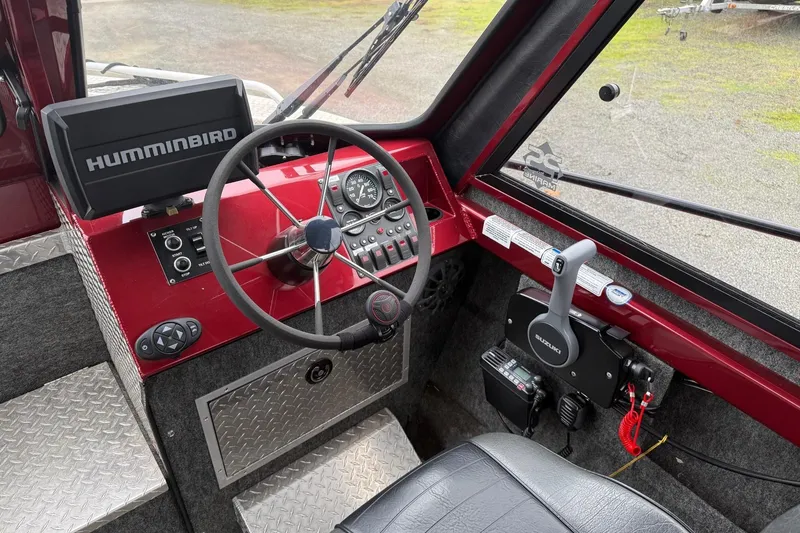 Slide: The Image of Storage compartment in a 2010 Thunder Jet 21 Luxor OB boat with safety gear and accessories. - 23