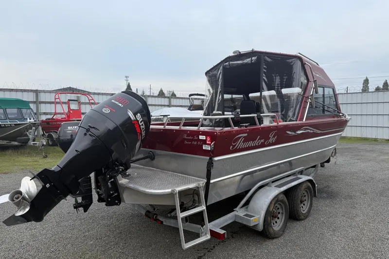 Slide: The Image of 2010 Thunder Jet 21 Luxor OB boat with Suzuki outboard motors on a trailer. - 3