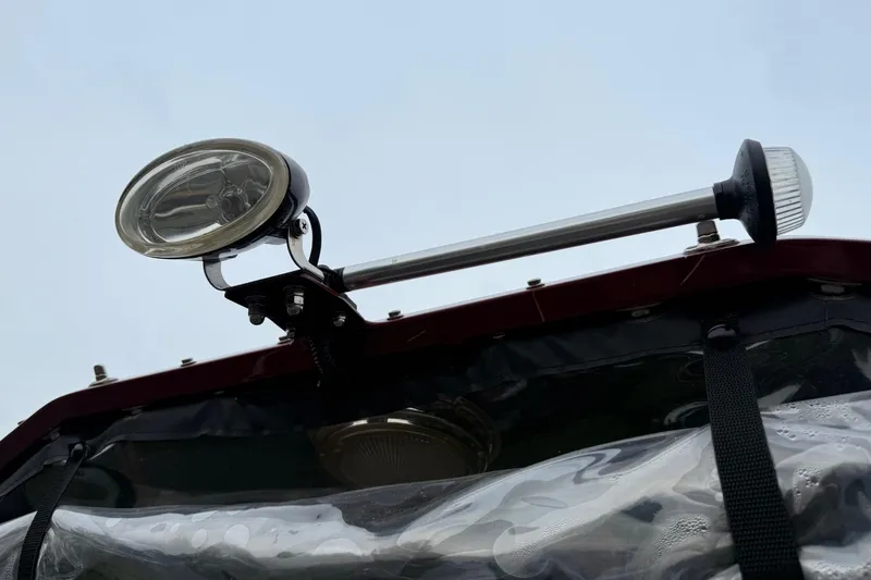 Slide: The Image of 2010 Thunder Jet 21 Luxor OB boat with red exterior and metal rod holders. - 43