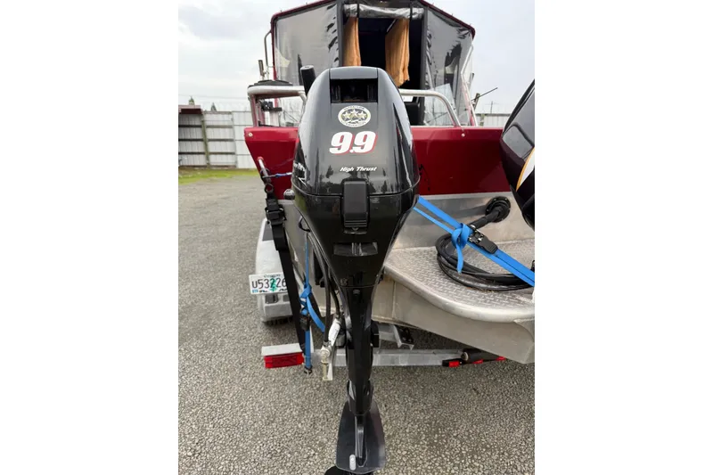 Slide: The Image of 2010 Thunder Jet 21 Luxor OB boat, maroon exterior, parked outdoors. - 46