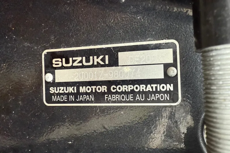 Slide: The Image of 2010 Thunder Jet 21 Luxor OB with outboard motor, parked on a trailer. - 48