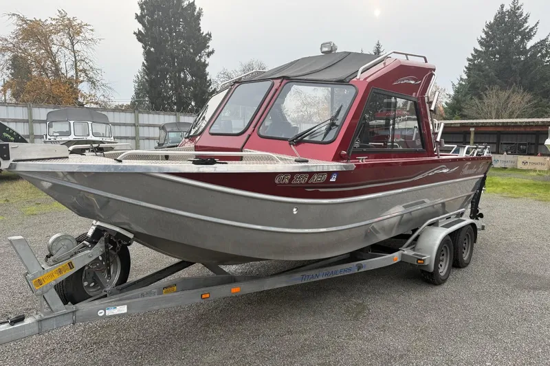 Slide: The Image of Trailer hitch and wheel of 2010 Thunder Jet 21 Luxor OB boat on gravel. - 6