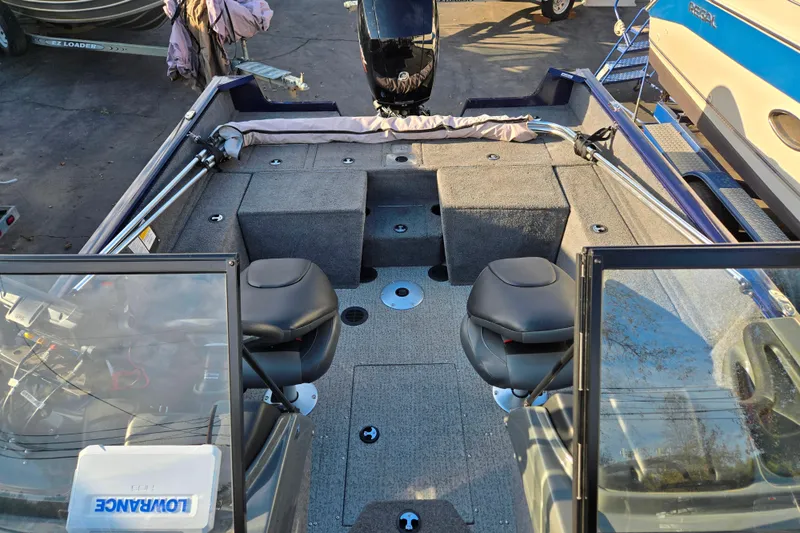 Slide: The Image of 2021 Tracker Pro Guide V-175 Combo boat interior with seating and storage compartments. - 100