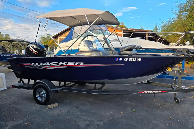 Slide: The Image of 2021 Tracker Pro Guide V-175 Combo boat on trailer, parked outdoors. - 92