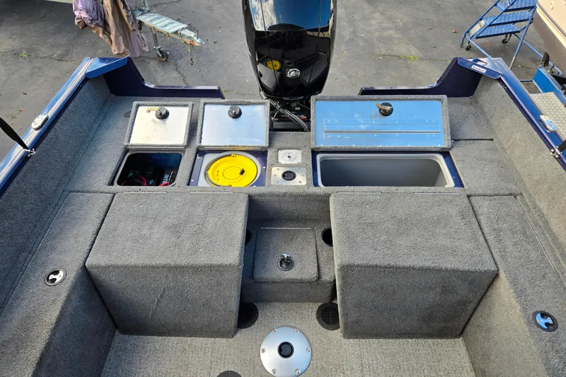 Slide: The Image of 2021 Tracker Pro Guide V-175 Combo boat interior with storage compartments and motor. - 94