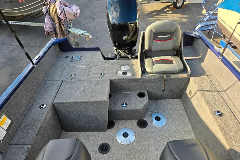 Slide: The Image of 2021 Tracker Pro Guide V-175 Combo boat interior with seating and storage compartments. - 97