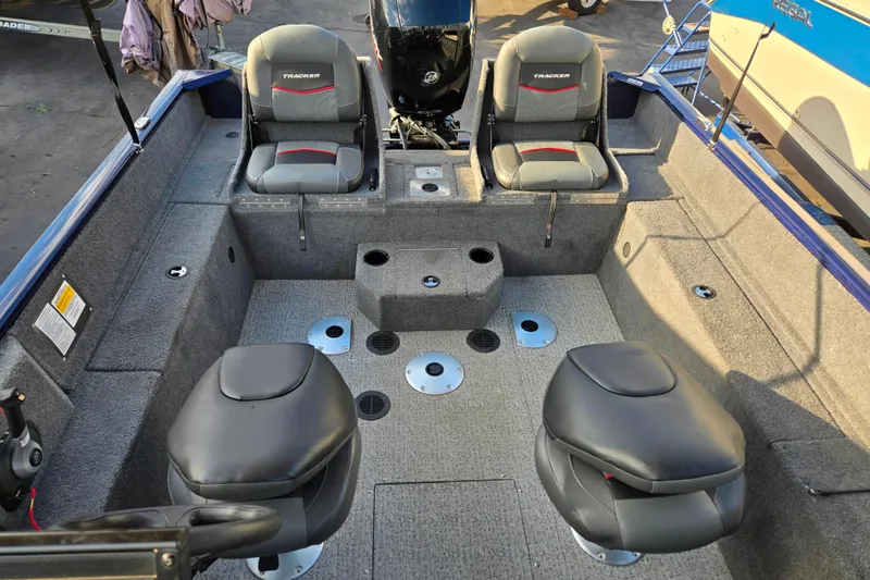 Slide: The Image of 2021 Tracker Pro Guide V-175 Combo boat interior with seating and motor. - 98
