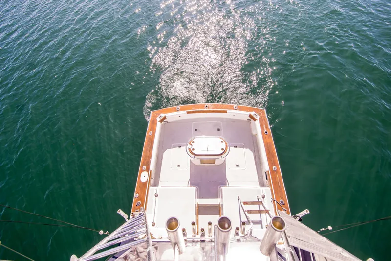 Slide: The Image of Aerial view of 1987 Blackfin 32 Flybridge boat on sparkling water. - 14