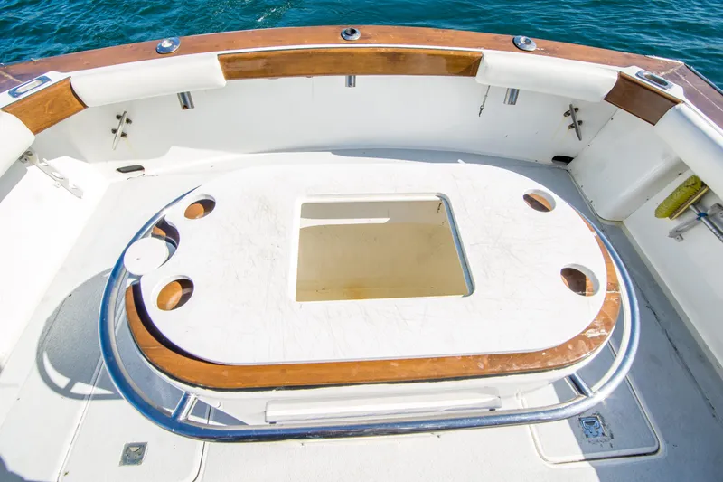 Slide: The Image of 1987 Blackfin 32 Flybridge boat deck with fishing rod holders and ocean view. - 17