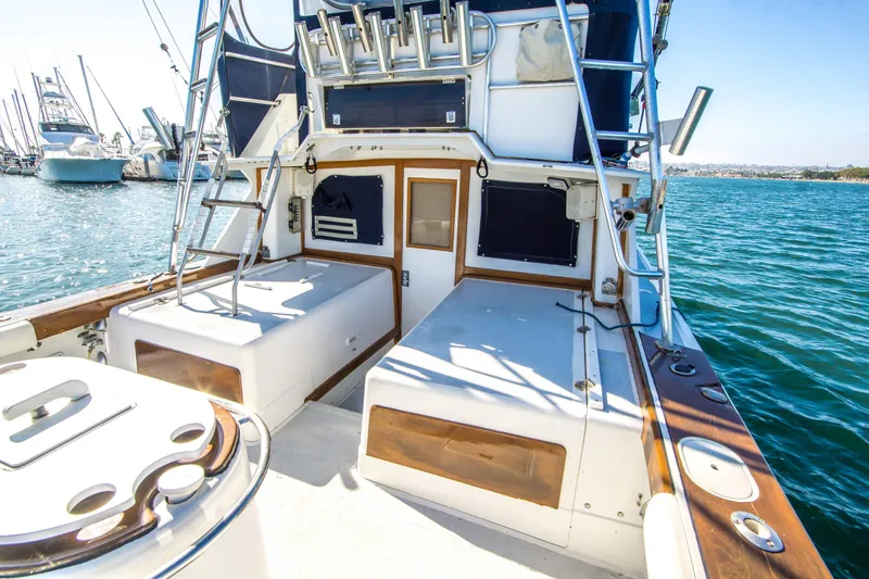 Slide: The Image of 1987 Blackfin 32 Flybridge boat with spacious deck and fishing rod holders. - 20