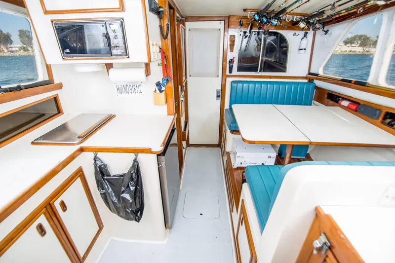 Slide: The Image of Interior of 1987 Blackfin 32 Flybridge boat with dining area and kitchenette. - 25