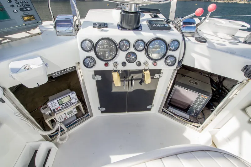 Slide: The Image of Control panel of a 1987 Blackfin 32 Flybridge boat with gauges and electronics. - 41