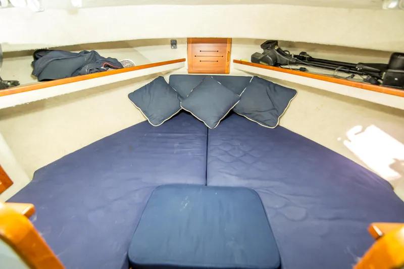 Slide: The Image of 1987 Blackfin 32 Flybridge cabin interior with blue cushions and storage shelves. - 47