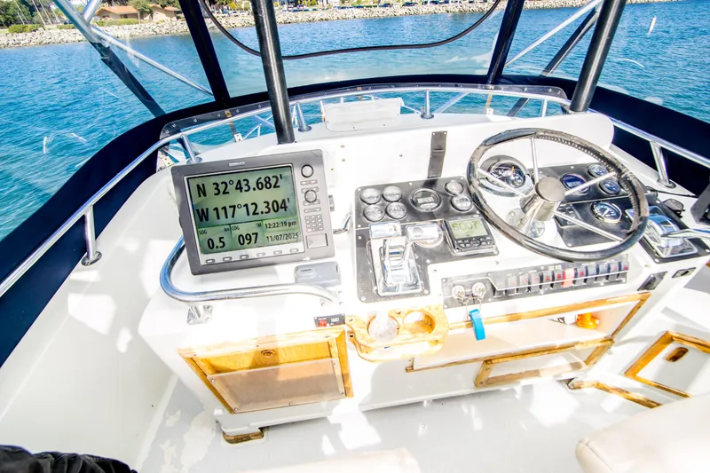 Slide: The Image of 1987 Blackfin 32 Flybridge helm with GPS coordinates and navigational instruments. - 8