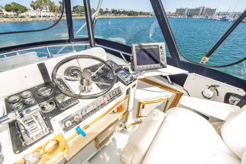 Slide: The Image of 1987 Blackfin 32 Flybridge helm with steering wheel, gauges, and navigation equipment. - 9