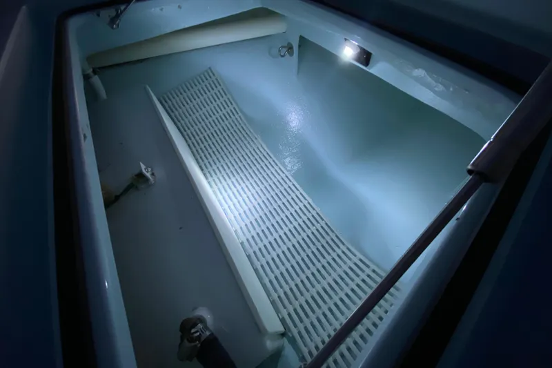 Slide: The Image of Interior view of a 2005 Hell's Bay Devilray boat compartment with lighting. - 10