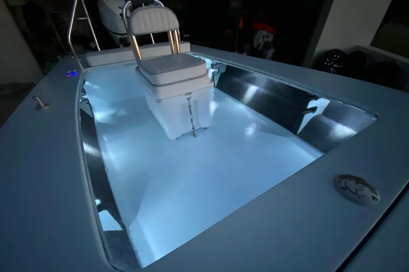 Slide: The Image of 2005 Hell's Bay Devilray boat interior with illuminated deck and seating. - 11