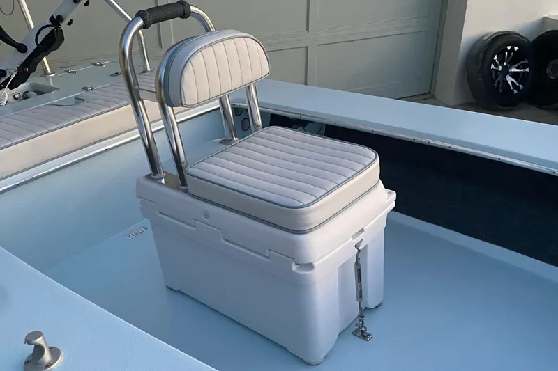 Slide: The Image of 2005 Hell's Bay Devilray boat interior with cushioned seat and cooler setup. - 12