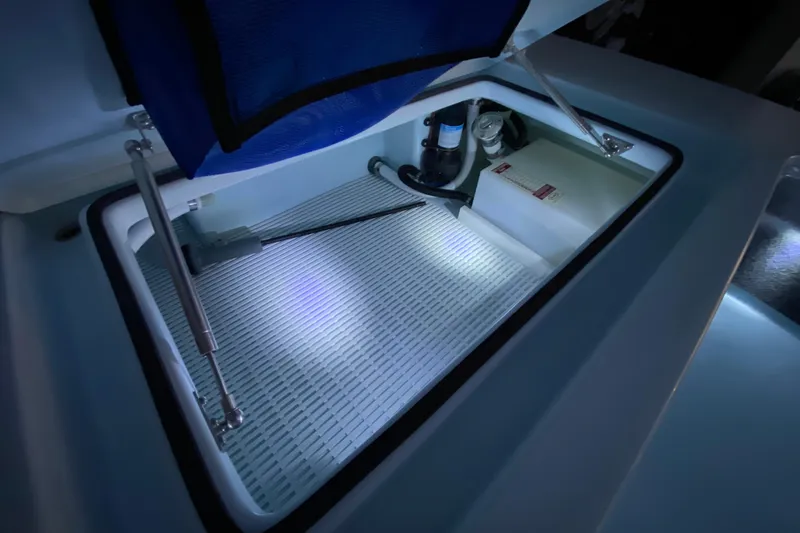 Slide: The Image of 2005 Hell's Bay Devilray boat compartment with illuminated interior and mechanical components. - 14